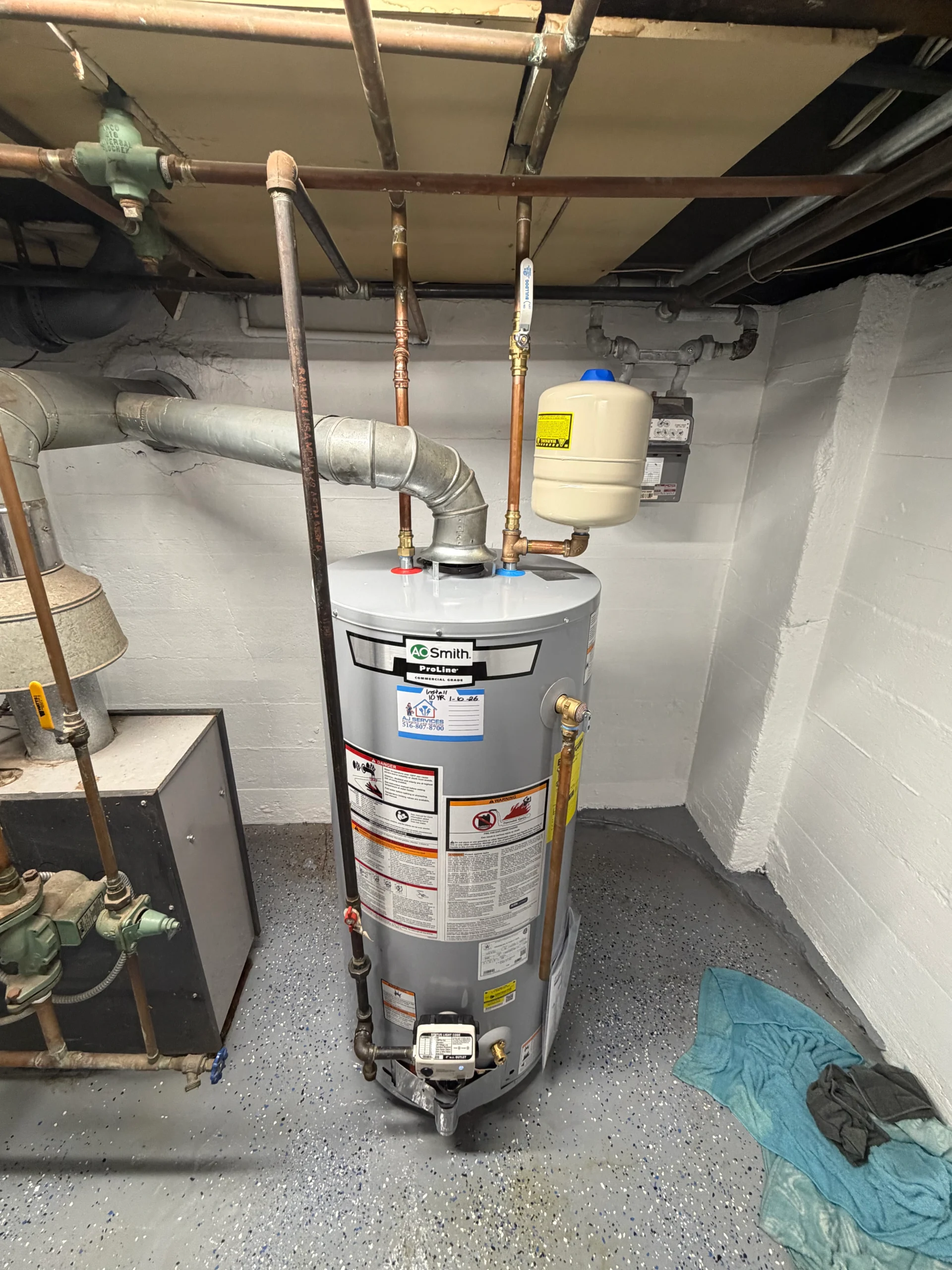 AO Smith gas water heater installation with expansion tank and code-compliant venting in Long Island home